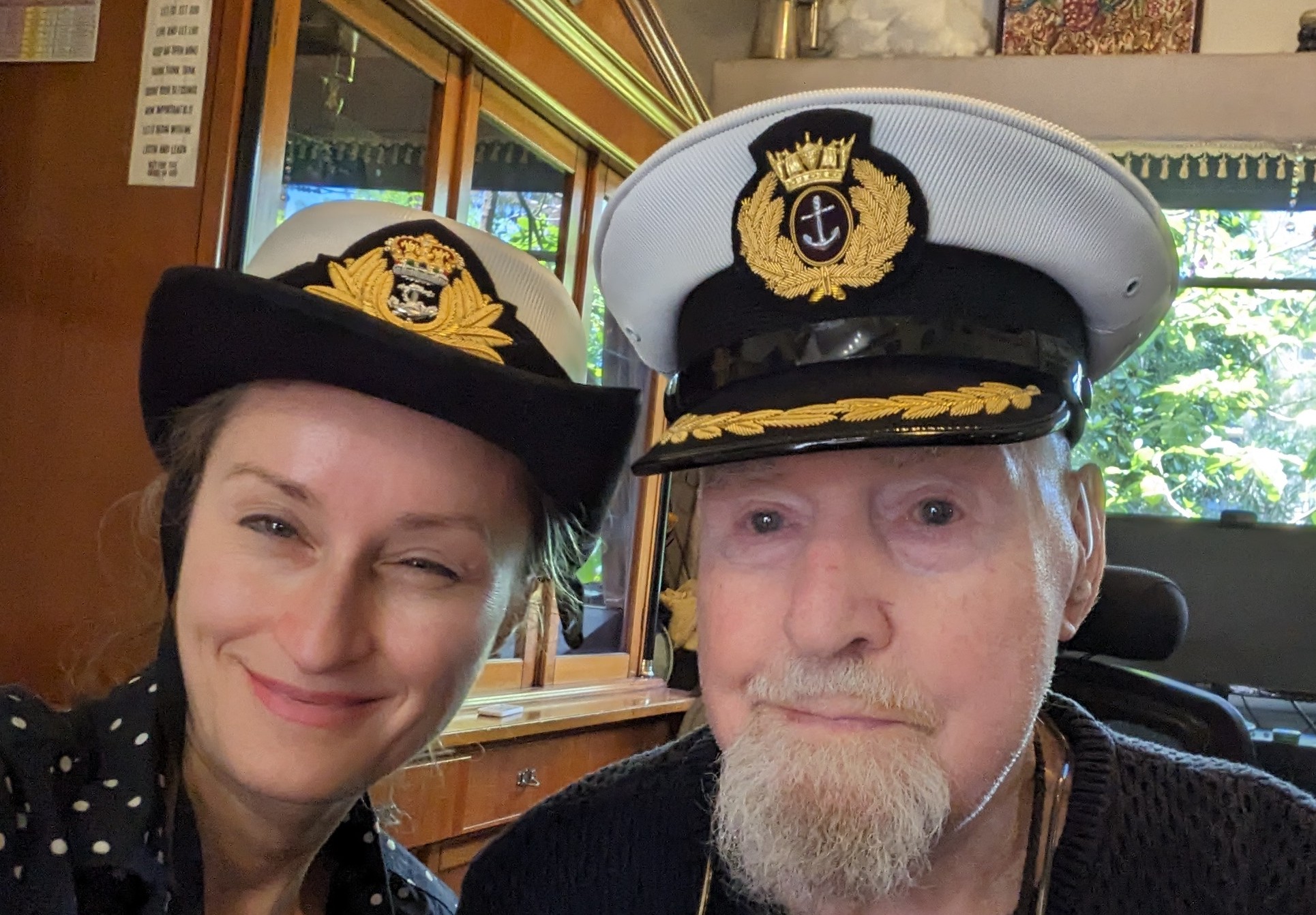 Kat Adamson with Sailor Bob — both in sailor's caps, smiling